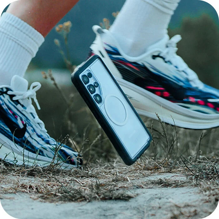 Phone case with a phone inside, being dropped by a person running