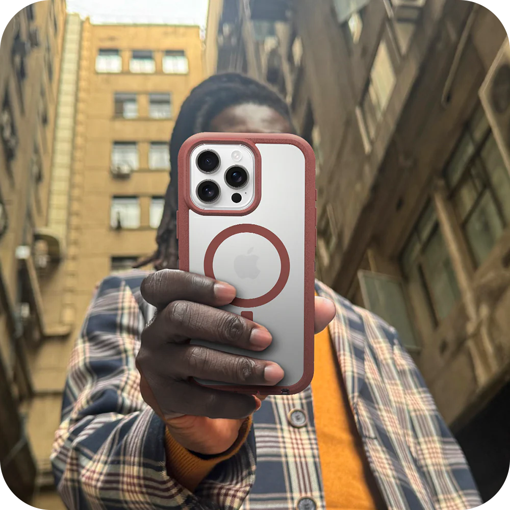 Person holding a phone with a distinctive case in an urban setting