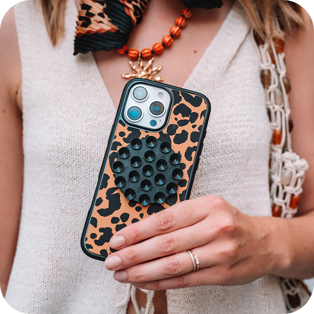 Woman holding leopard print  case with magsafe accessory