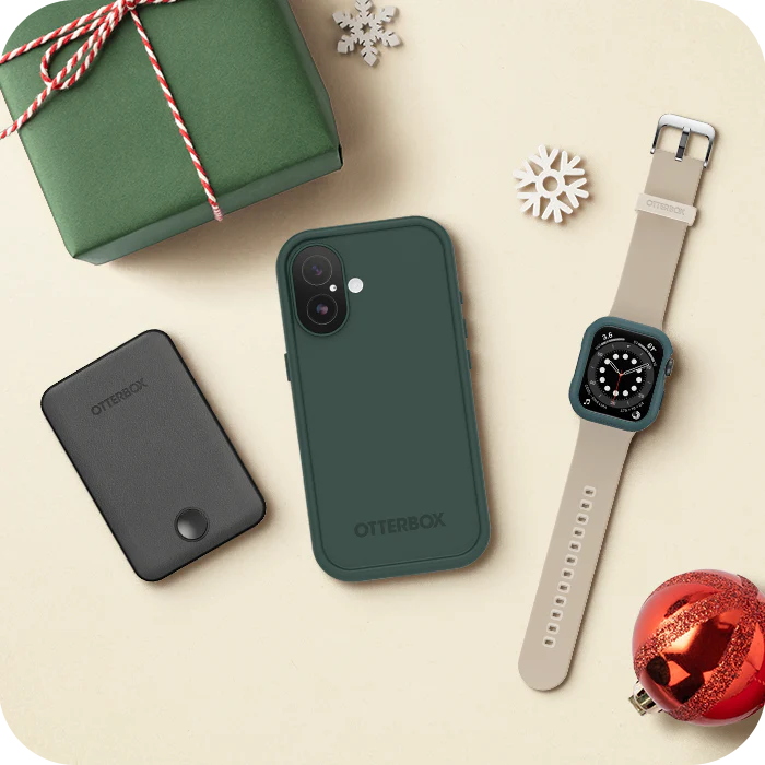 Phone case, phone, watch, and gift box with Christmas decorations on a beige surface