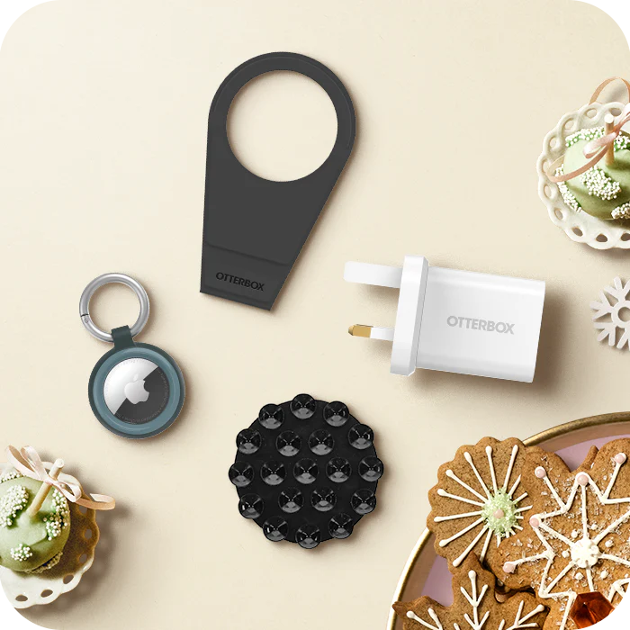Collection of OtterBox products on a decorative surface with cookies and green treats.
