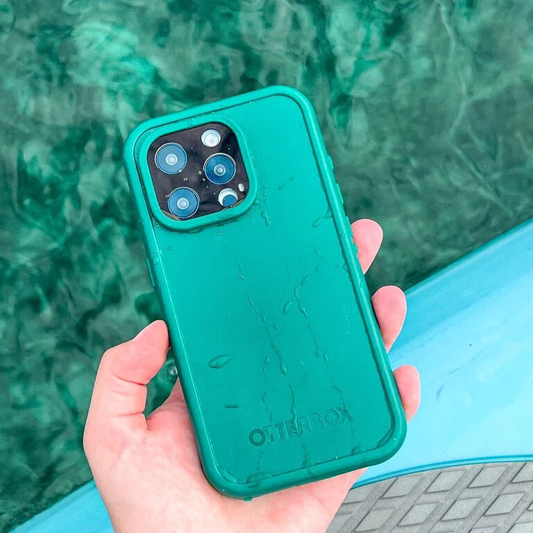 Person holding a teal phone case with a green marble background